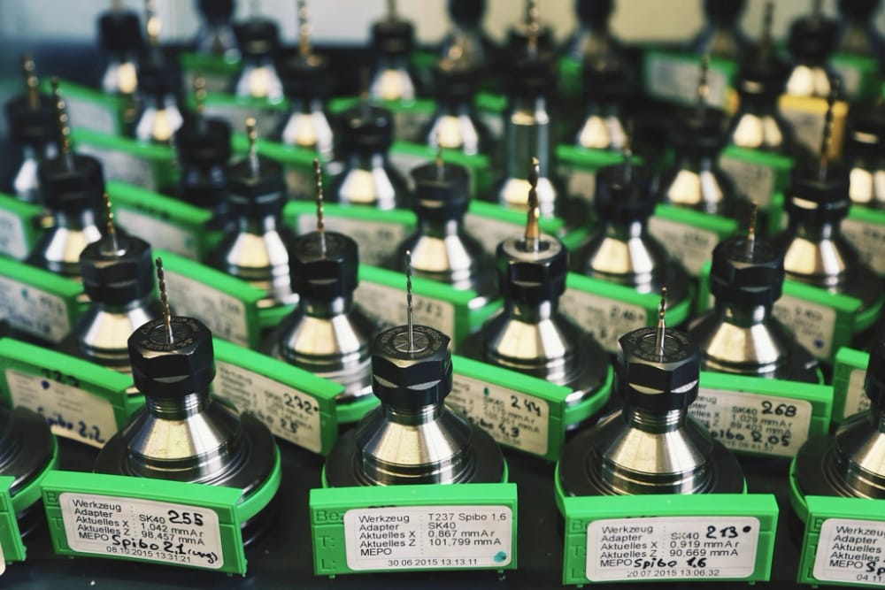 CNC tool holders on tagged stands, the industrial industry page hero.